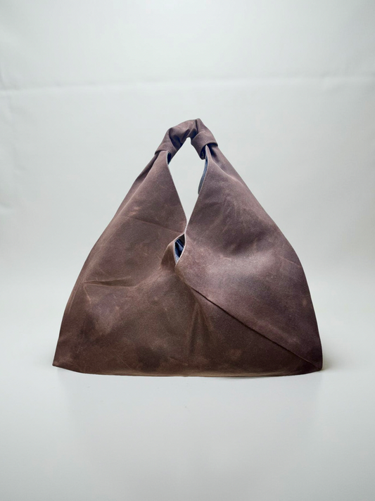 Brown waxed canvas origami midi bag by Esra Kayira brand.