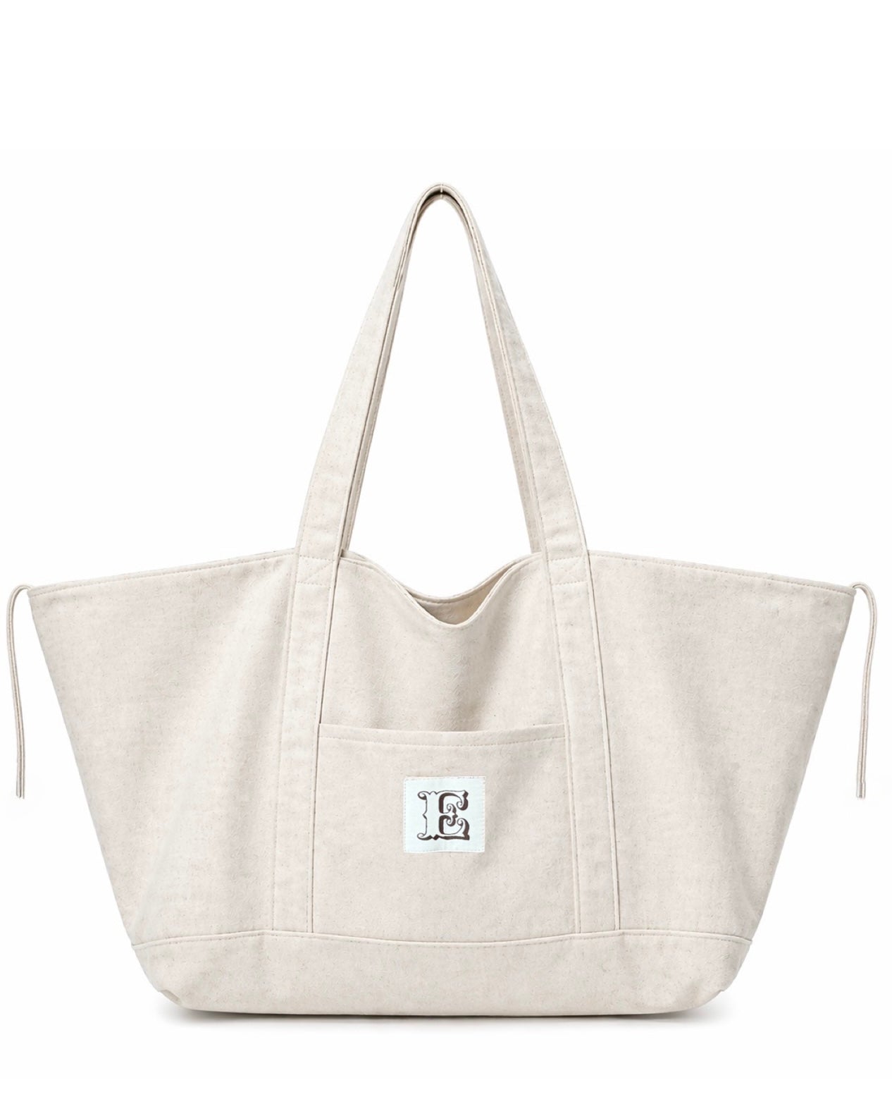 Stone color linen  tote bag with a small white label on a white background