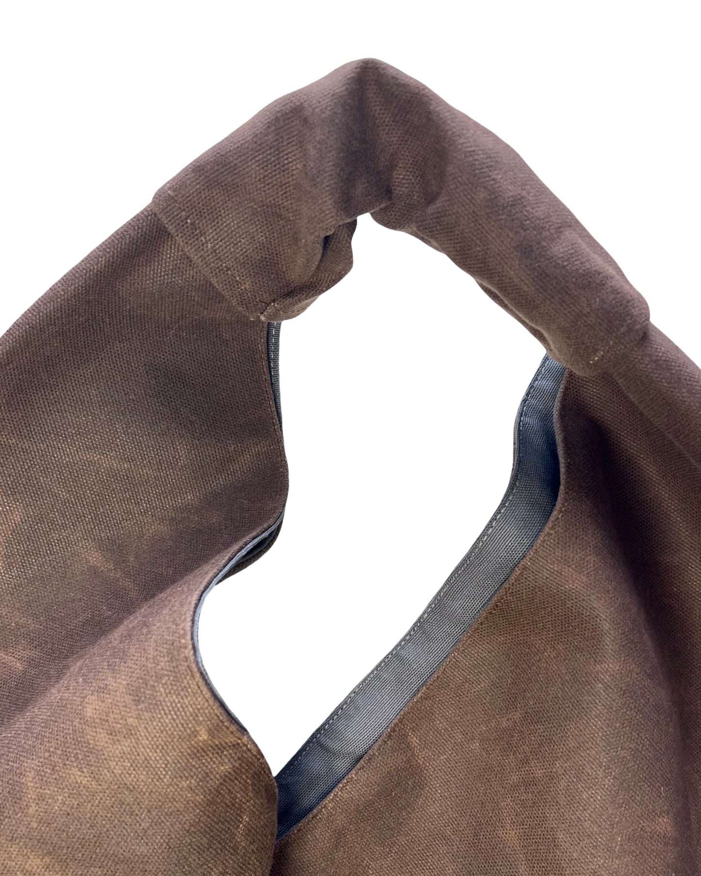 Brown waxed canvas origami midi bag texture and material detail
